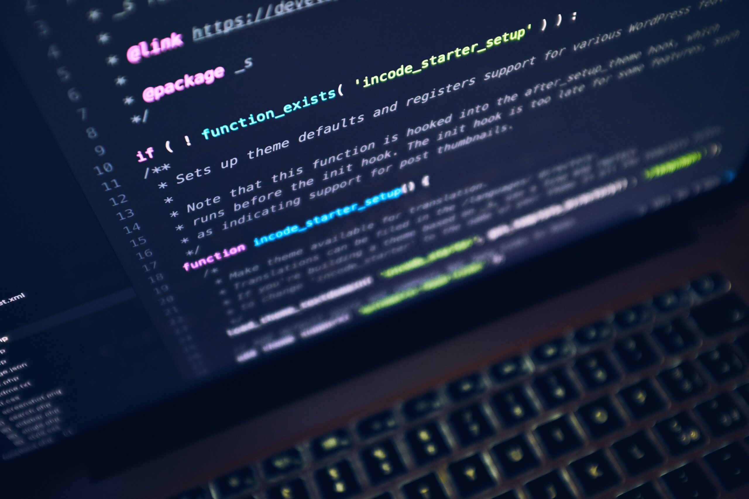 Developer working at a laptop with a code editor open