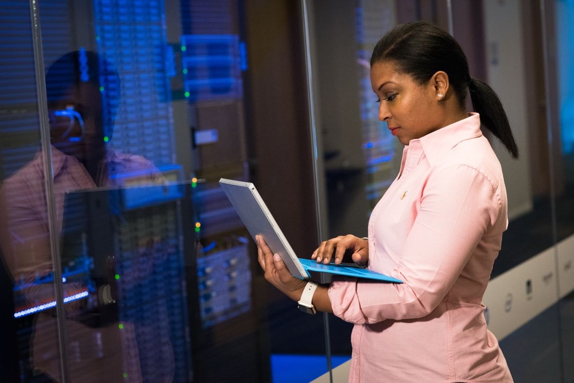 A software engineer works at a laptop in a server room, illustrating the kind of coding workflow teams should evaluate